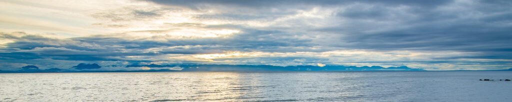 Seashore with mountains on the horizon