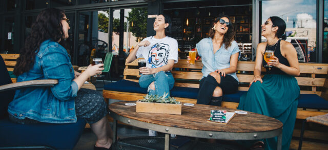 four-friends-talking-over-a-beer